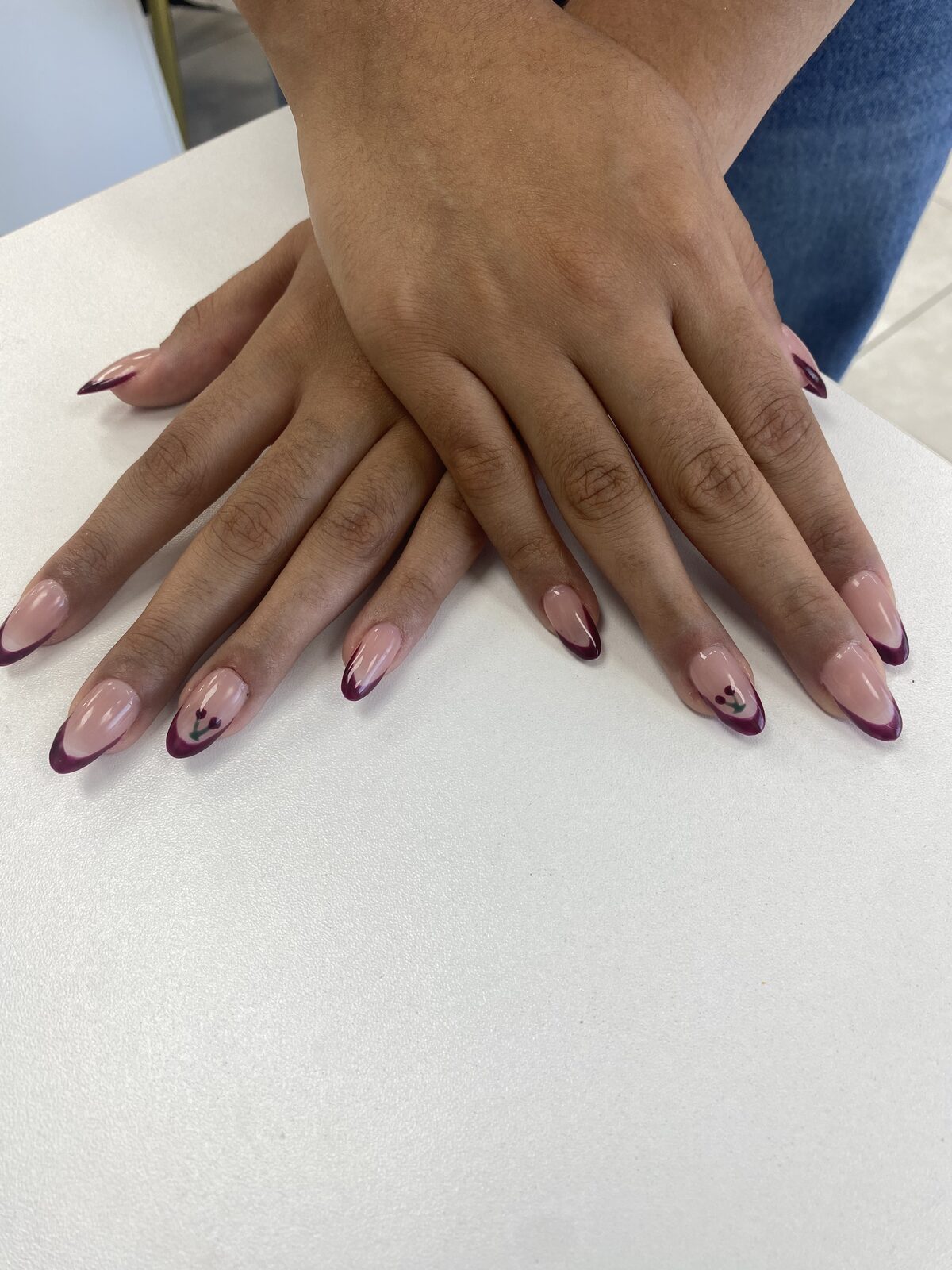 Burgundy almond French manicure on two hands