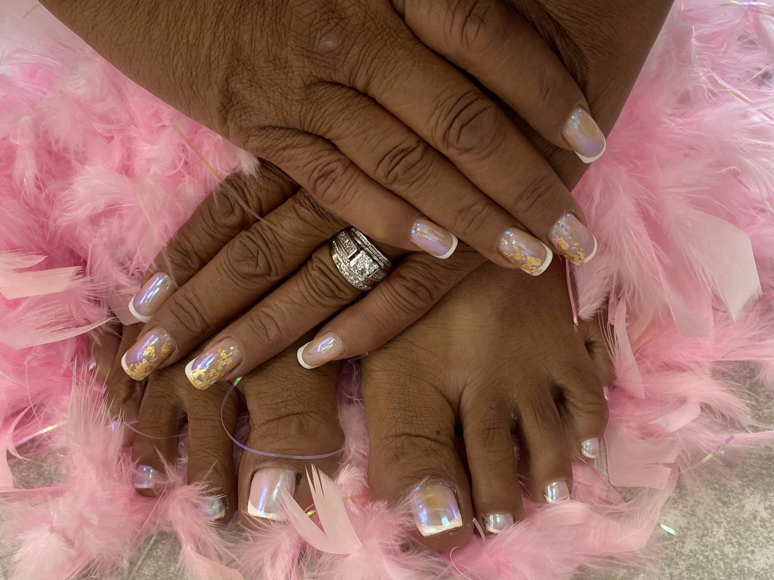 Iridescent French manicure with pink feather boa at Hideaway Nail Design