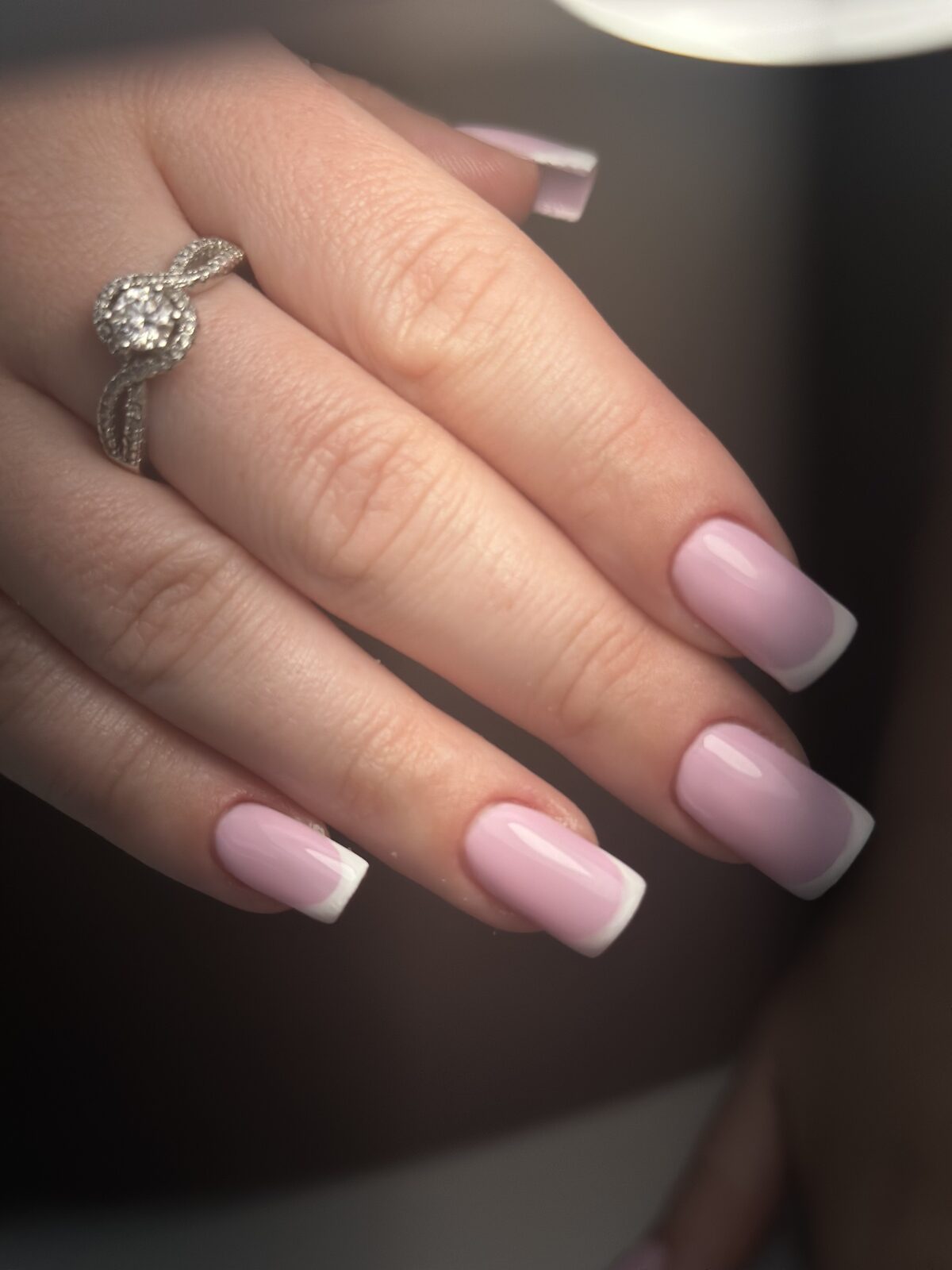Soft pink French gel manicure with a diamond ring
