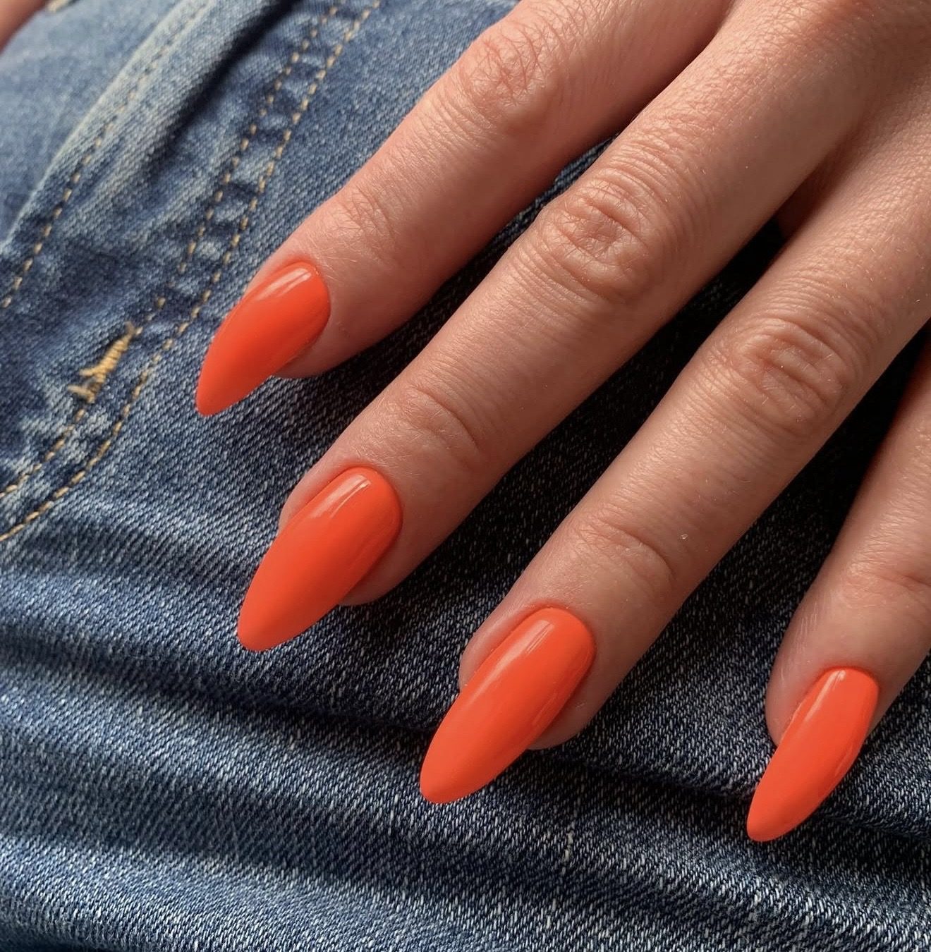 Bright tangerine orange stiletto nails at Hideaway Nail Design